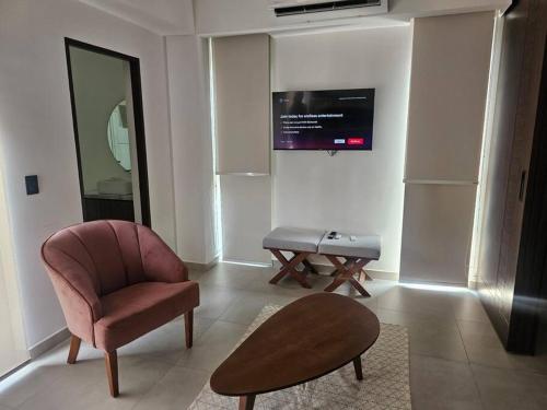 a living room with a chair and a table at Loft nuevo en Zona Romántica 203 in Puerto Vallarta