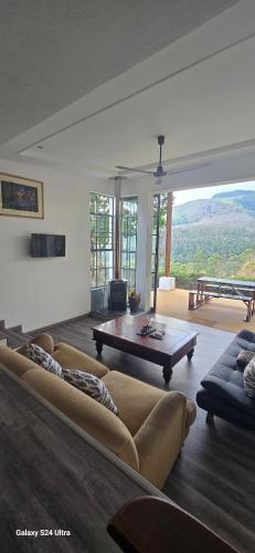 a living room with a couch and a table at Villa by Voila in Mbabane