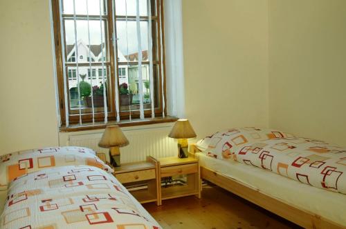 a bedroom with two beds and a window at Apartments Rakoczi in Žilina