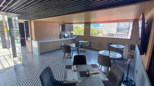 a restaurant with tables and chairs in a room at Alia Inn Boutique WTC in Mexico City