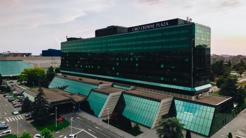 a large glass building with a sign on it at Crowne Plaza Belgrade by IHG in Belgrade