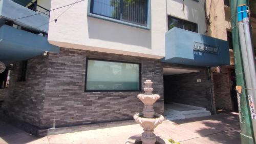 a building with a tv on a brick wall at Alia Inn Boutique WTC in Mexico City
