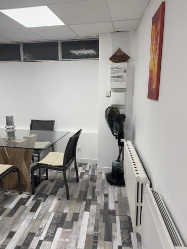 an office with a table and chairs and a fan at Arhomeplus-hunic in Autun