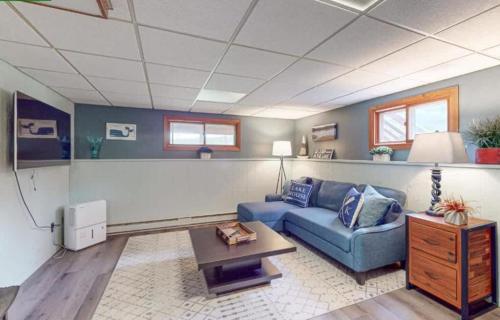 a living room with a blue couch and a table at Lilly Pad Landing in Hazelhurst