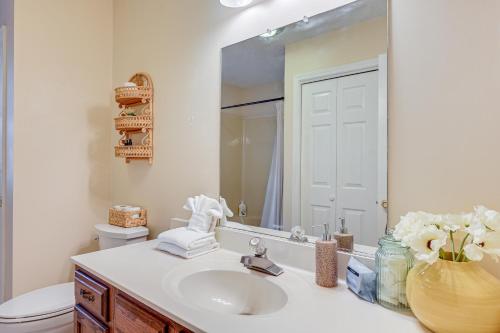 a bathroom with a sink and a mirror at Home with Large Yard 6 Mi to Dtwn Winston-Salem! in Winston-Salem