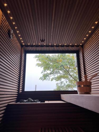 a room with a large window with a tree outside at Radice Verde in Cissone