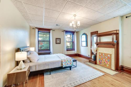 a bedroom with a bed and a fireplace at Spacious Pittsburgh Rental Walk to Frick Park! in Pittsburgh