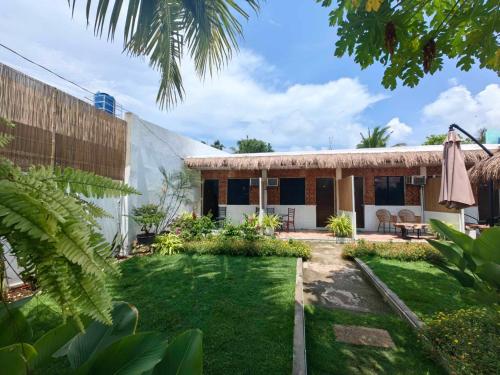 a house with a garden in front of it at 5R Tourist Inn & Restaurant in Pooc