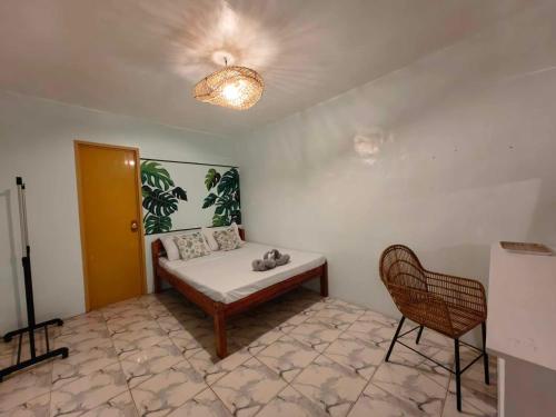 a room with a bed and a chair in it at 5R Tourist Inn & Restaurant in Pooc