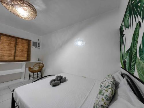 a bedroom with a bed with a stuffed animal on it at 5R Tourist Inn & Restaurant in Pooc