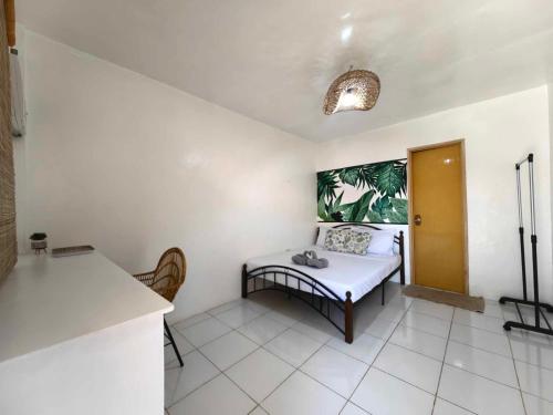a room with a table and a bed in it at 5R Tourist Inn & Restaurant in Pooc