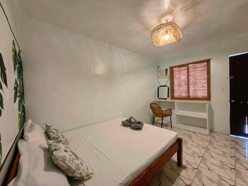 a bedroom with a bed and a chair in it at 5R Tourist Inn & Restaurant in Pooc