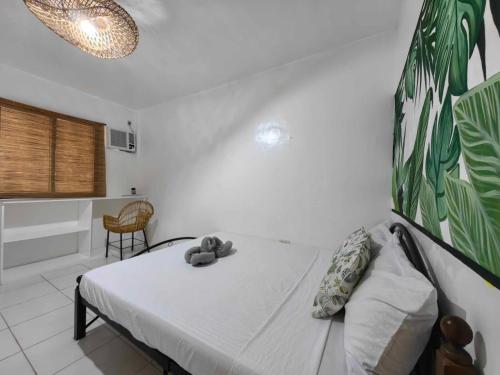 a bedroom with a bed with a white wall at 5R Tourist Inn & Restaurant in Pooc