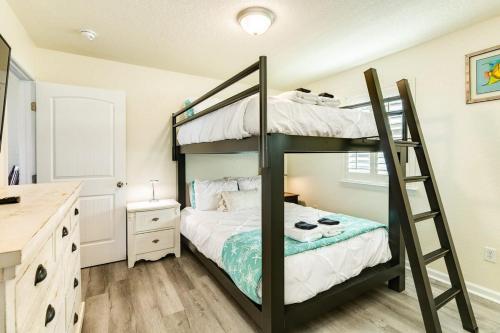 a bedroom with a bunk bed with a ladder at Breathtaking Island Views from Multiple Decks! in Surfside Beach