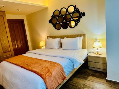 a bedroom with a large bed with white pillows at Centaurus Apartment Islamabad in Islamabad