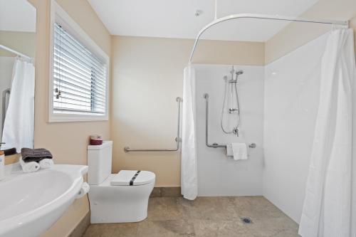 a bathroom with a sink and a toilet and a shower at Newina Rotorua in Rotorua