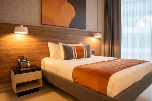 a hotel room with a bed and a telephone at Grand Hotel&Casino Vía Dorada in Pachuca de Soto