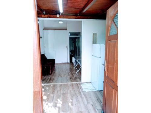 an open door into a living room with a table at L'Escapade Antillaise, T2 calme, proche de tout, jardin in Baie-Mahault