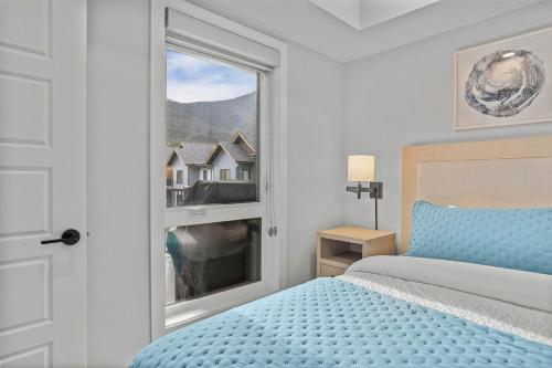a white bedroom with a bed and a window at Perfect 3 bed-2 bath Top Floor Hot Tub Heated Pool Gym in Dead Man's Flats