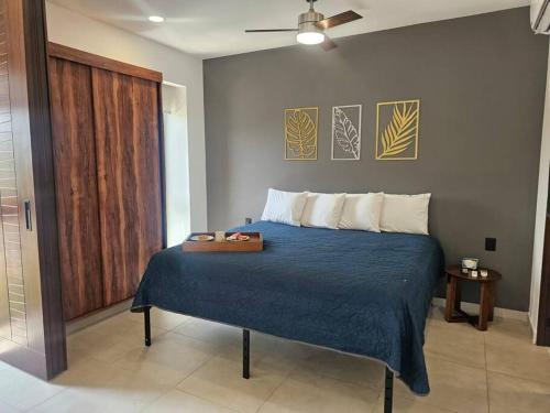 a bedroom with a bed with a blue comforter at Estudio de ensueño con alberca 303 in Puerto Vallarta