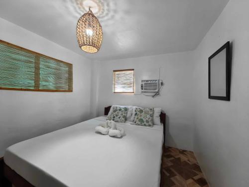 a bedroom with a large white bed in a room at 5R Tourist Inn & Restaurant in Pooc