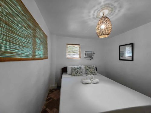 a bedroom with a white bed in a room at 5R Tourist Inn & Restaurant in Pooc