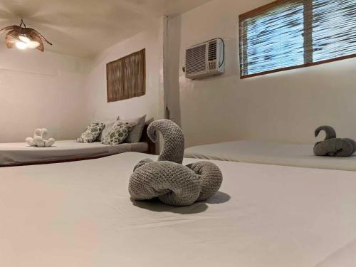 a room with two beds with swans on the bed at 5R Tourist Inn & Restaurant in Pooc