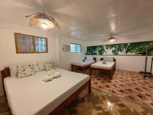 a room with a bed and two tables in it at 5R Tourist Inn & Restaurant in Pooc