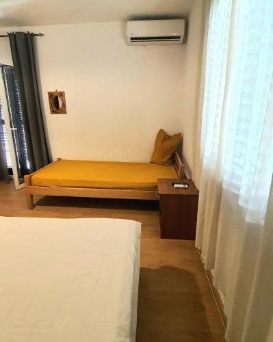 Una cama o camas en una habitación de Vojinovic Apartments