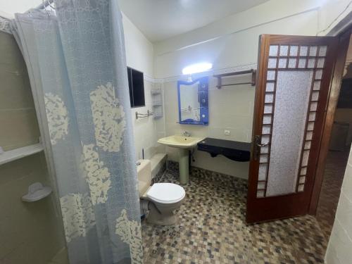 a bathroom with a toilet and a sink at Extrait d'atlas in Tafza