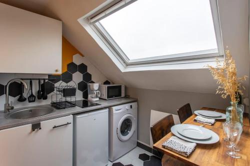 une cuisine avec un évier et une machine à laver dans l'établissement Le Nid d Amiens 2 pers 8 min Centre ville & gare, à Amiens