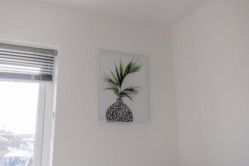 a pineapple plant on a wall next to a window at Modern 3 Bed House-Free Parking in Cramlington