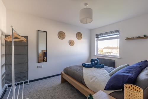 a bedroom with a bed and a mirror at Modern 3 Bed House-Free Parking in Cramlington