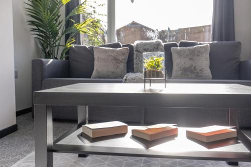 a coffee table in a living room with a couch at Modern 3 Bed House-Free Parking in Cramlington