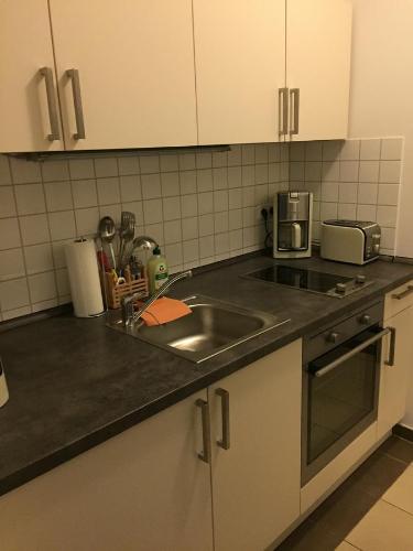 a kitchen with a sink and a counter top at City FEWO Leipzig in Leipzig