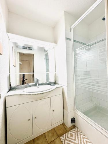 une salle de bain avec un lavabo et une douche dans l'établissement 15 min à pieds de la mer- piscine privée- place de parking privée, à Saint Pierre La Mer