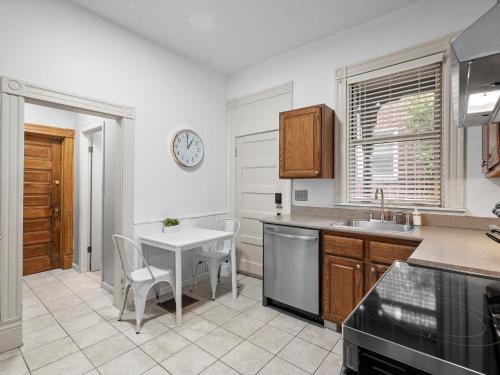 a kitchen with a table and a sink and a clock at Oakland, Pittsburgh !F Unique and Stylish Private Bedroom with Private Bathroom in Pittsburgh