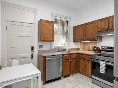 a kitchen with wooden cabinets and a sink at Oakland, Pittsburgh !F Unique and Stylish Private Bedroom with Private Bathroom in Pittsburgh