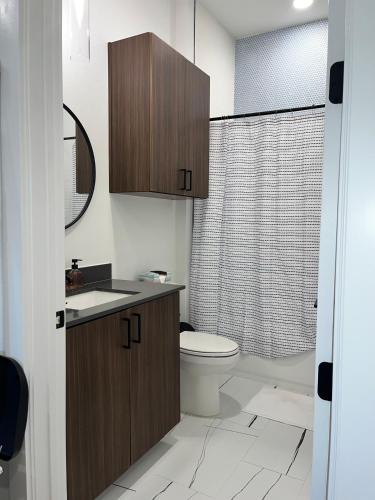 a bathroom with a toilet and a sink and a shower at Hip Luxury Condo Getaway- Near Gruene in New Braunfels