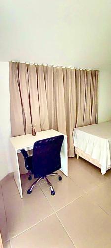 a bedroom with a desk and a bed and a deskensional at Residencial Temporada Aracaju in Aracaju