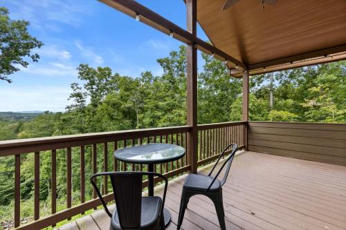 a patio with chairs and a table on a deck at 7 Min to DT Blue Ridge~Hot Tub~Fire Pit~Sleeps 12 in Blue Ridge