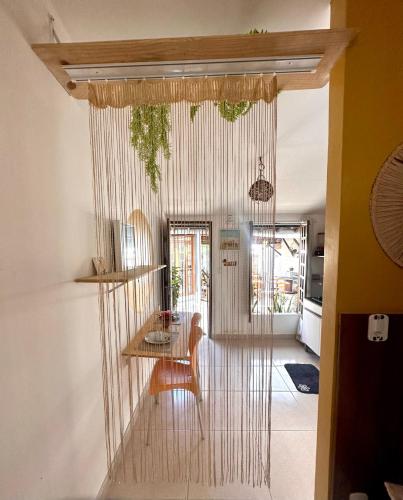 a dining room with a table and a chair at Residencial Temporada Aracaju in Aracaju