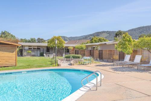 a swimming pool in front of a house at Contenta Inn in Carmel Valley