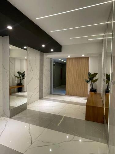 a lobby with a hallway with potted plants in it at Depto Monroe 2 in Buenos Aires