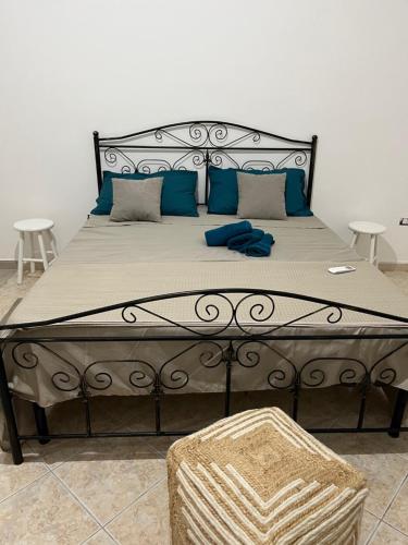 a large bed with blue pillows in a bedroom at 21 L'Agrumeto in Marittima