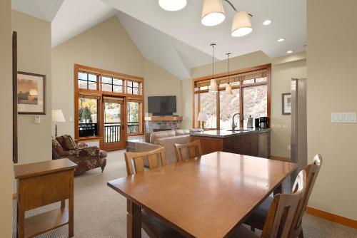 a kitchen and living room with a wooden table and chairs at Pinecone Perch Capitol Peak Lodge #3227 in Snowmass Village