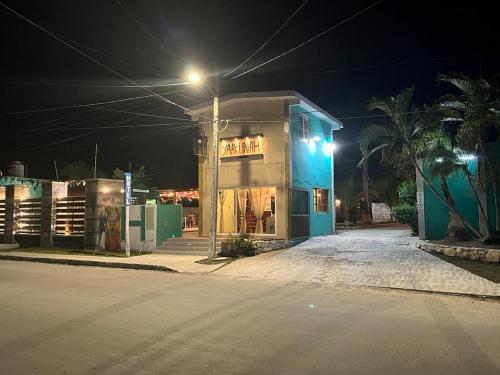 a building on the side of a street at night at Hotel yaakunah in Escárcega