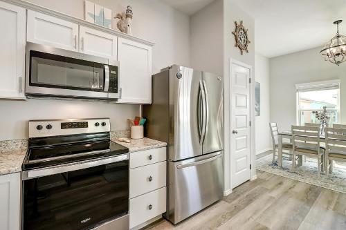 a kitchen with a stainless steel refrigerator and a microwave at Turtle Cove in Rockport