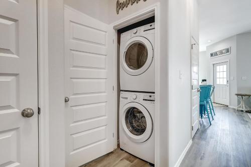 a white laundry room with a washer and dryer at Turtle Cove in Rockport