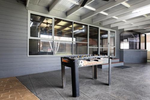 a ping pong table in the middle of a room at Charmer on Olive in Albury